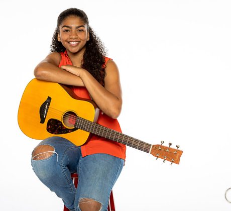 In studio portrait of a high school senior with her guitar. Portrait by Brisson Imagery