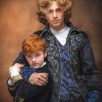 Two bothers pose wearing Hamilton Costumes, older brother has younger brother in a loving headlock. Portrait by Brisson Imagery.
